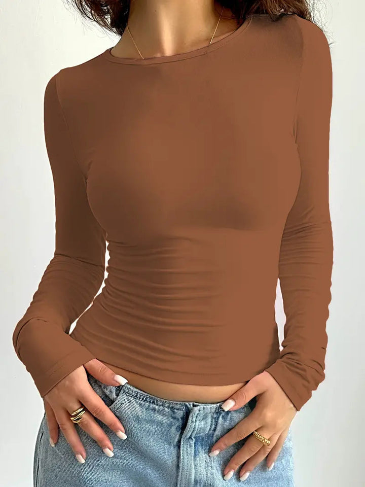 "Camisola Feminina Slim Fit de Manga Longa" can be rewritten as "Camisola Feminina de Manga Longa com Corte Slim Fit".