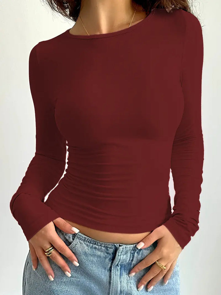 "Camisola Feminina Slim Fit de Manga Longa" can be rewritten as "Camisola Feminina de Manga Longa com Corte Slim Fit".